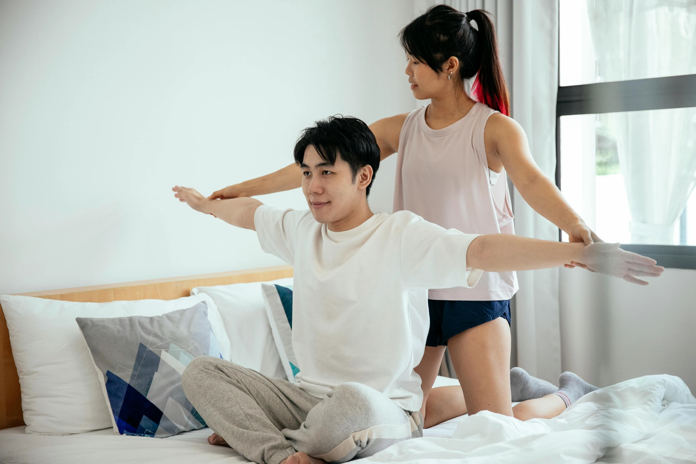 a man sitting on top of a bed next to a woman, a cartoon, pexels contest winner, hurufiyya, dynamic stretching, set on singaporean aesthetic, waist reaching ponytail, straight arms