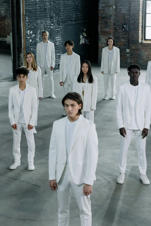 a group of people dressed in white standing in a room, inspired by Vanessa Beecroft, trending on pexels, thin young male, jc park, wearing track and field suit, titanium white