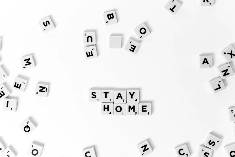 a pile of scrabbles sitting on top of a white surface, a black and white photo, pexels, sweet home, slay, stop frame animation, ad image