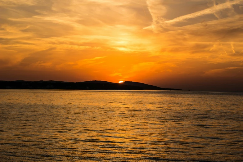 the sun is setting over a body of water, by Mathias Kollros, pexels contest winner, romanticism, croatian coastline, orange sun set, youtube thumbnail, brown