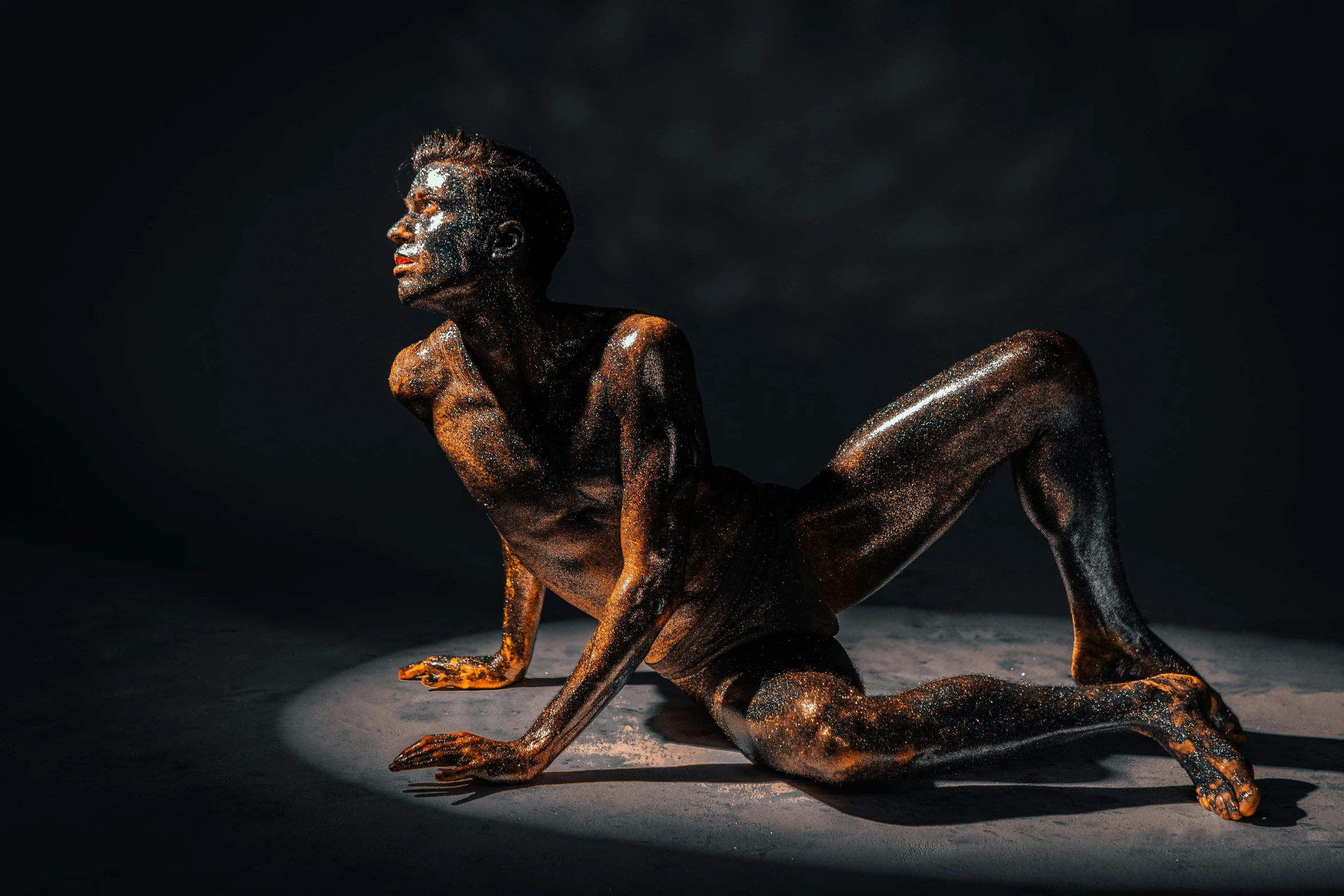 a naked woman with black paint on her body, a bronze sculpture, by Adam Marczyński, featured on zbrush central, young man, unsplash contest winning photo, crouching, brown skin like soil