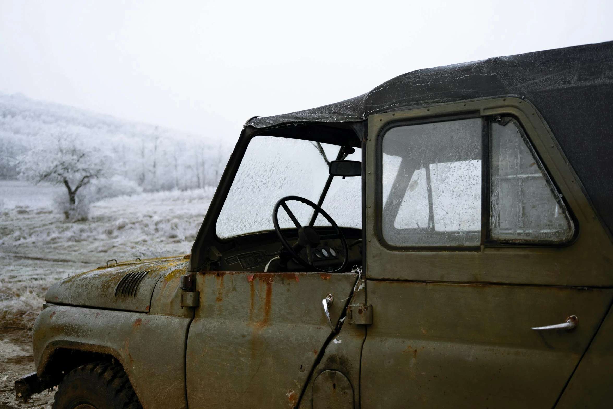 an old truck sitting in the middle of a snowy field, unsplash, auto-destructive art, land rover defender, ((rust)), square, interior shot