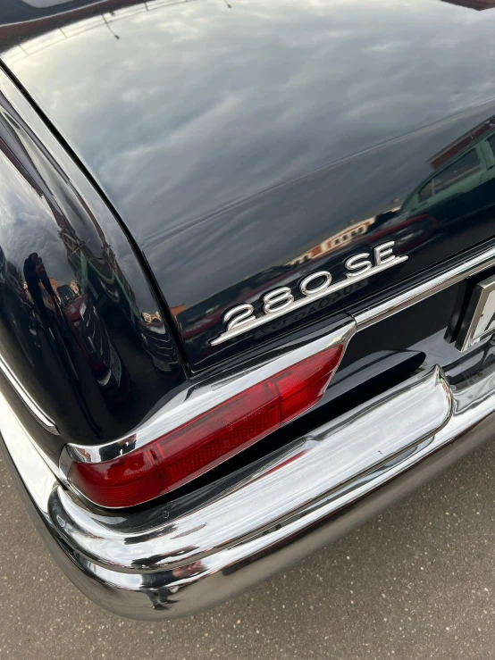 a black car parked in a parking lot, restored, very detailed labeling, photograph taken in 2 0 2 0, skin detail