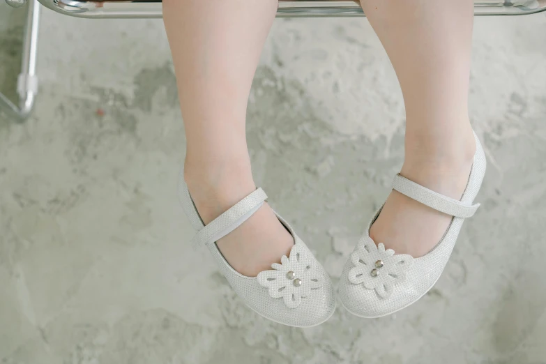 a close up of a person wearing white shoes, flower child, little kid, grey and silver, medium angle