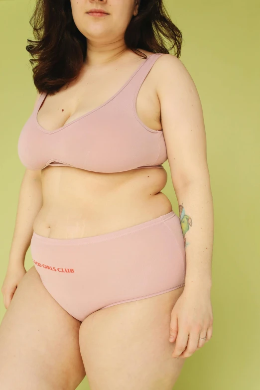 a woman in a pink underwear posing for a picture, varying thickness, round-cropped, uwu, like a catalog photograph