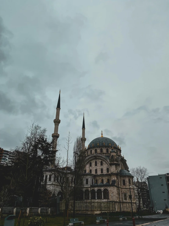a large building sitting on the side of a road, an album cover, by Ismail Acar, pexels contest winner, hurufiyya, neoclassical tower with dome, overcast!!!, mixture turkish and russian, overview