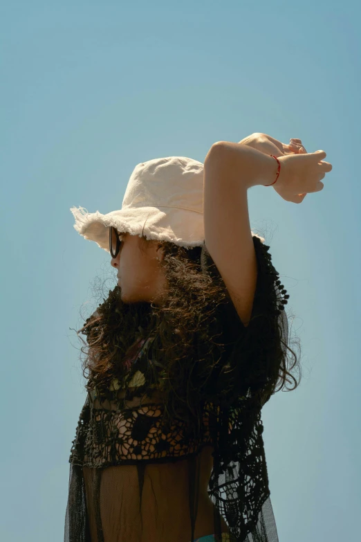 a woman in a white hat is flying a kite, an album cover, inspired by Ren Hang, unsplash, hairy arms, afternoon sunlight, profile pic, zoë kravitz