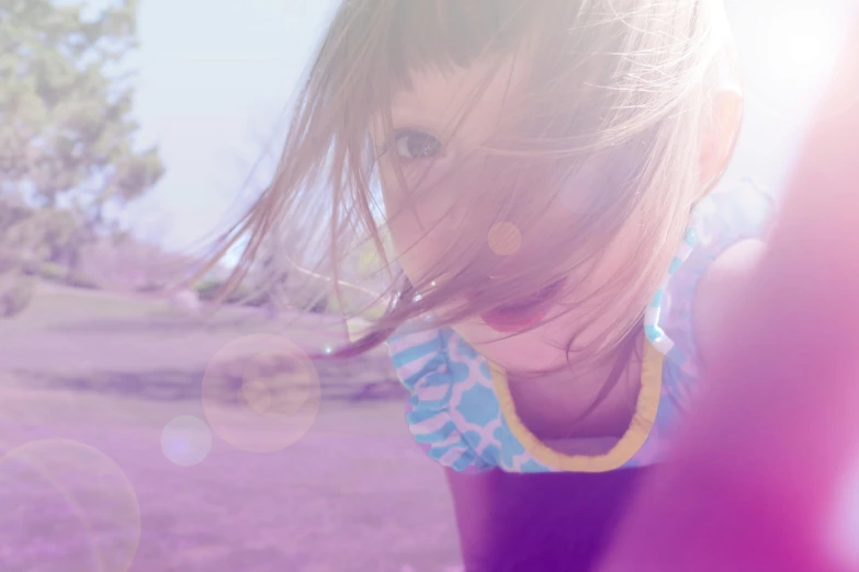 a little girl standing on top of a lush green field, a picture, unsplash, process art, second colours - purple, overexposed flash, glare face, having fun in the sun