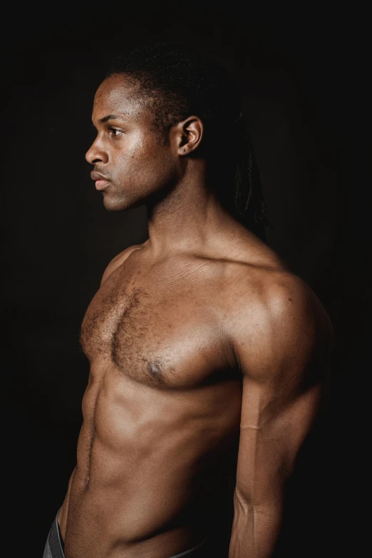a shirtless man standing in front of a black background, inspired by Theo Constanté, profile image, with brown skin, androgynous person, multiple stories
