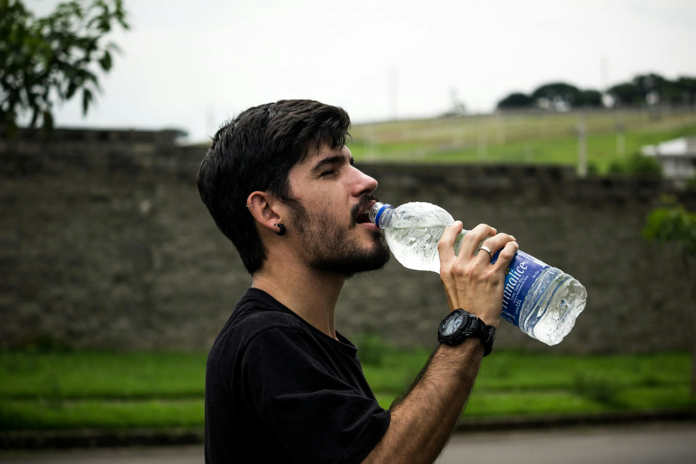 a man drinking water out of a plastic bottle, pexels contest winner, hyperrealism, sao paulo, avatar image, attractive photo, 278122496