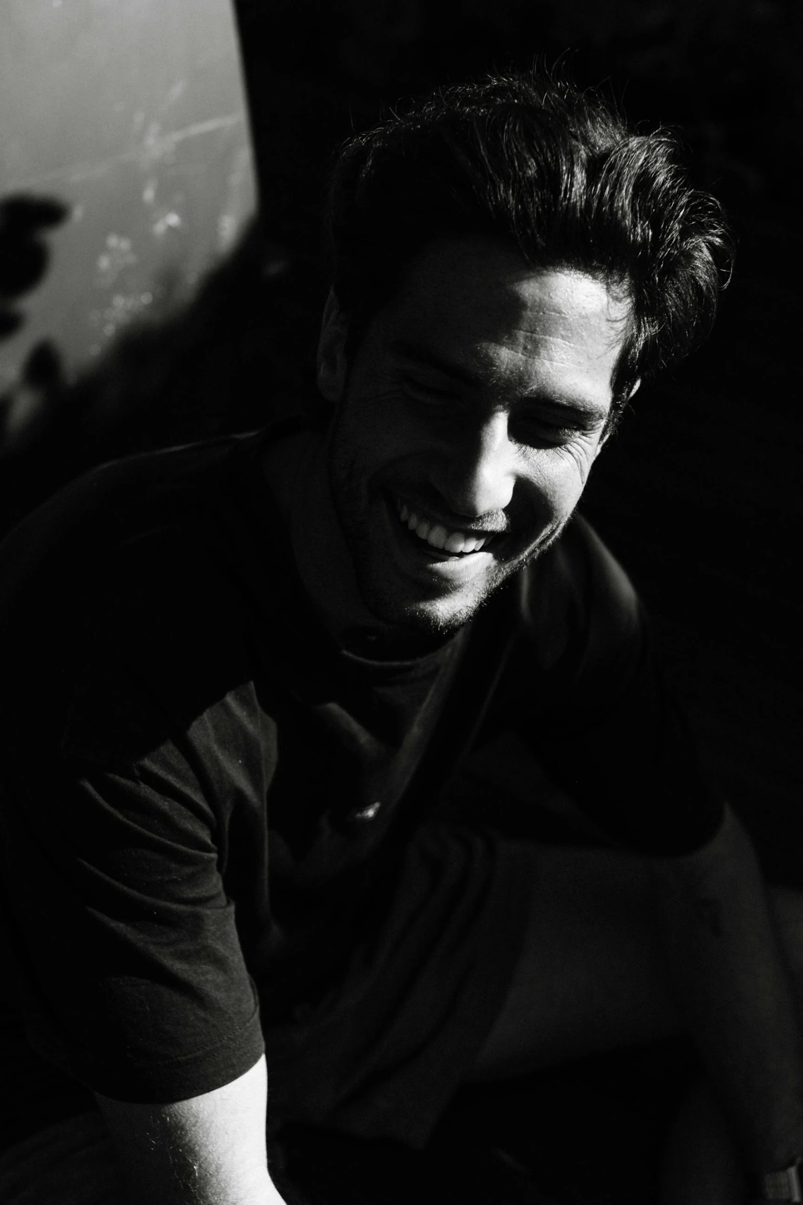 a black and white photo of a man smiling, a black and white photo, figuration libre, instagram post, greg rutowski, candid!! dark background, asher duran