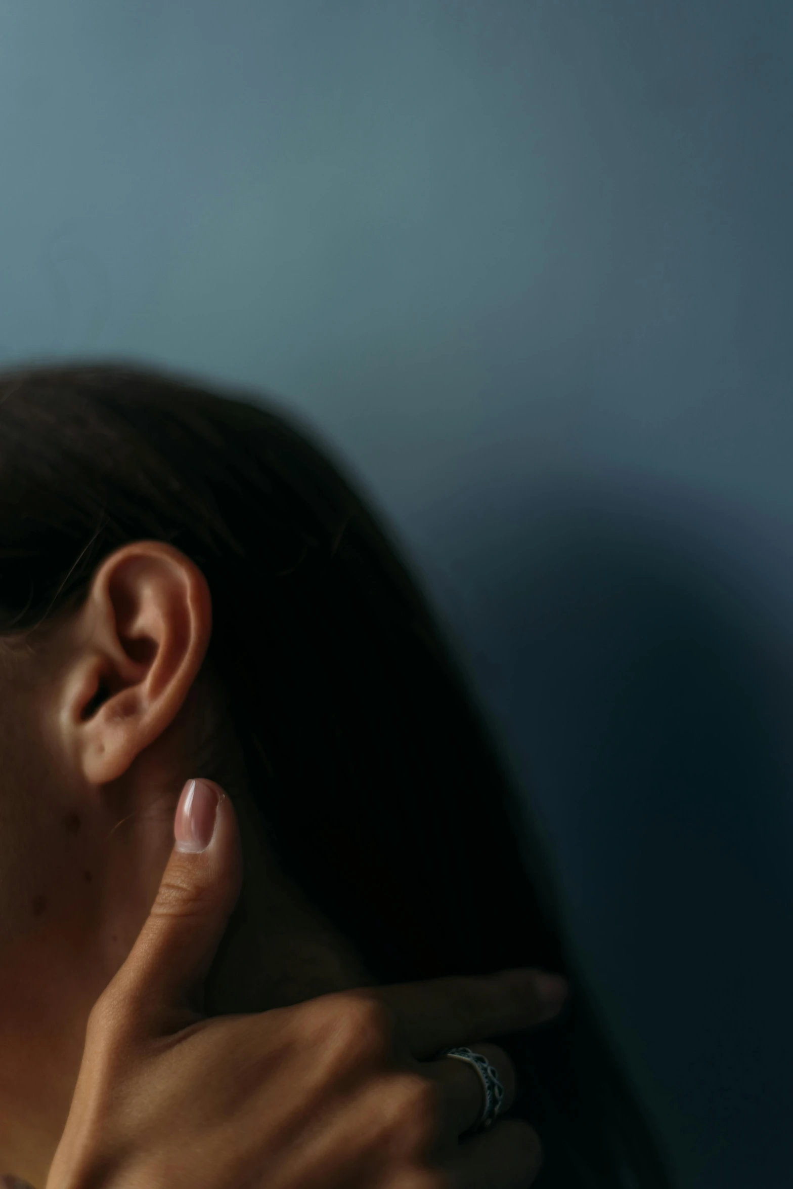 a woman brushing her teeth in front of a mirror, an album cover, by Elsa Bleda, trending on pexels, hyperrealism, chiroptera ears, with a blue background, close - up profile, tinnitus