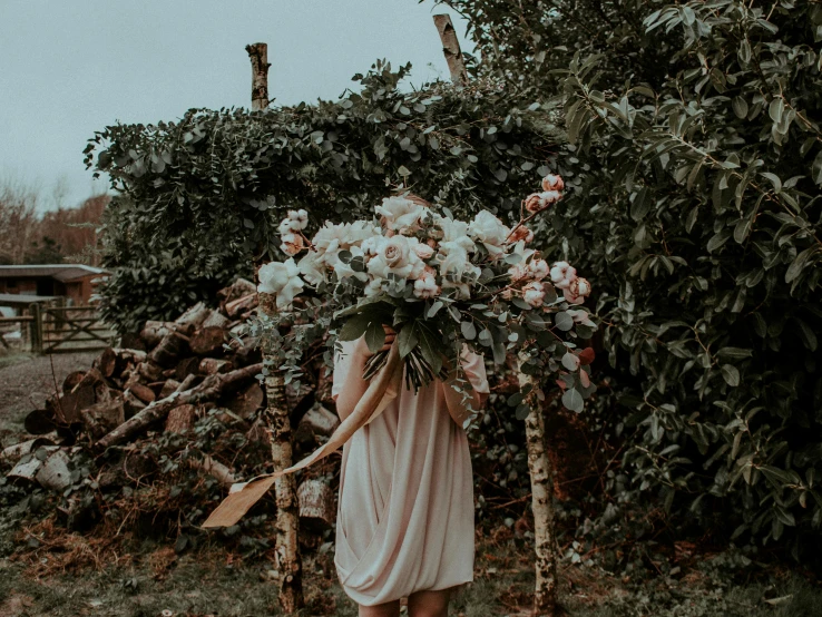 a woman in a dress holding a bunch of flowers, an album cover, by Emma Andijewska, pexels contest winner, lush chic garden, rustic, monia merlo, background image