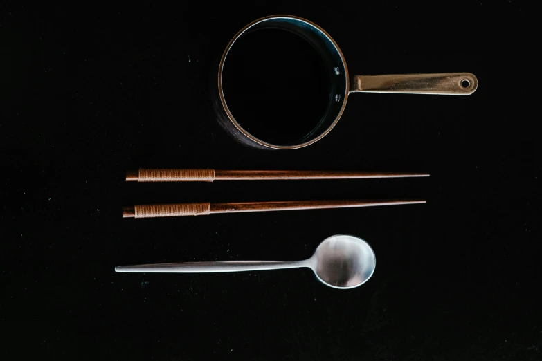 a pair of chopsticks sitting next to a cup of coffee, silver monocle, metal kitchen utensils, thumbnail, ebony