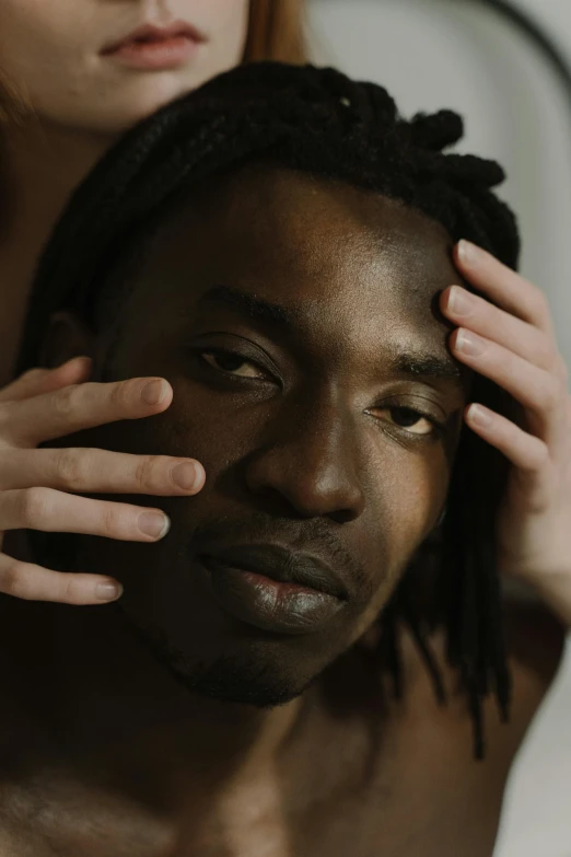 a woman combing a man's hair in front of a mirror, an album cover, inspired by Theo Constanté, trending on pexels, lil uzi vert, holding his hands up to his face, closeup headshot portrait, handsome male