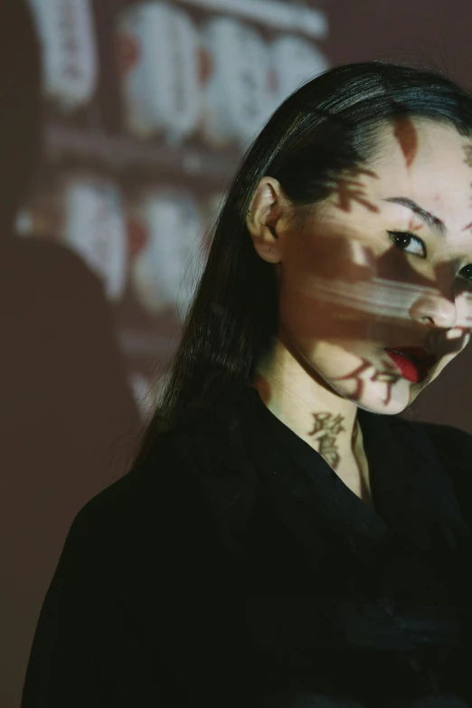 a woman holding a cell phone up to her face, an album cover, inspired by Taro Yamamoto, shadow play, cai guo-qiang, vampira, profile image