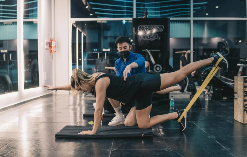 a man and a woman doing push ups in a gym, by Emma Andijewska, spacehip lands, sao paulo, low quality photo, kyza saleem