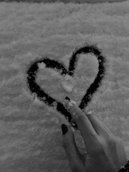 a person drawing a heart in the snow, a black and white photo, by Lucia Peka, 🐿🍸🍋, by :5 sexy: 7, perfect hands, devon cady-lee