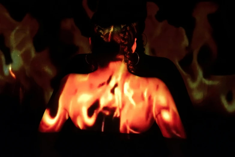 a woman standing in front of a fire, inspired by Anna Füssli, conceptual art, abstract claymation, satanic body, profile image, projection mapping