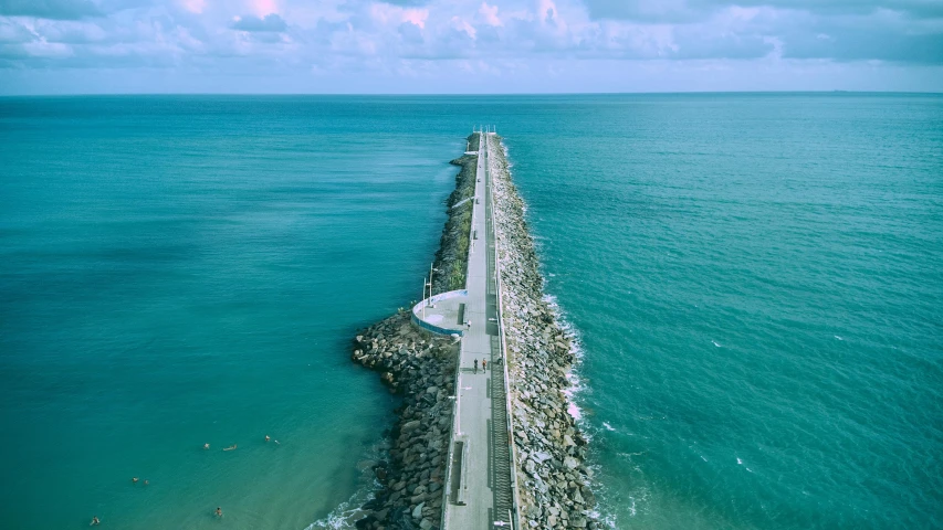 a long bridge over a body of water, pexels contest winner, turquoise ocean, a road leading to the lighthouse, near a jetty, rectangle