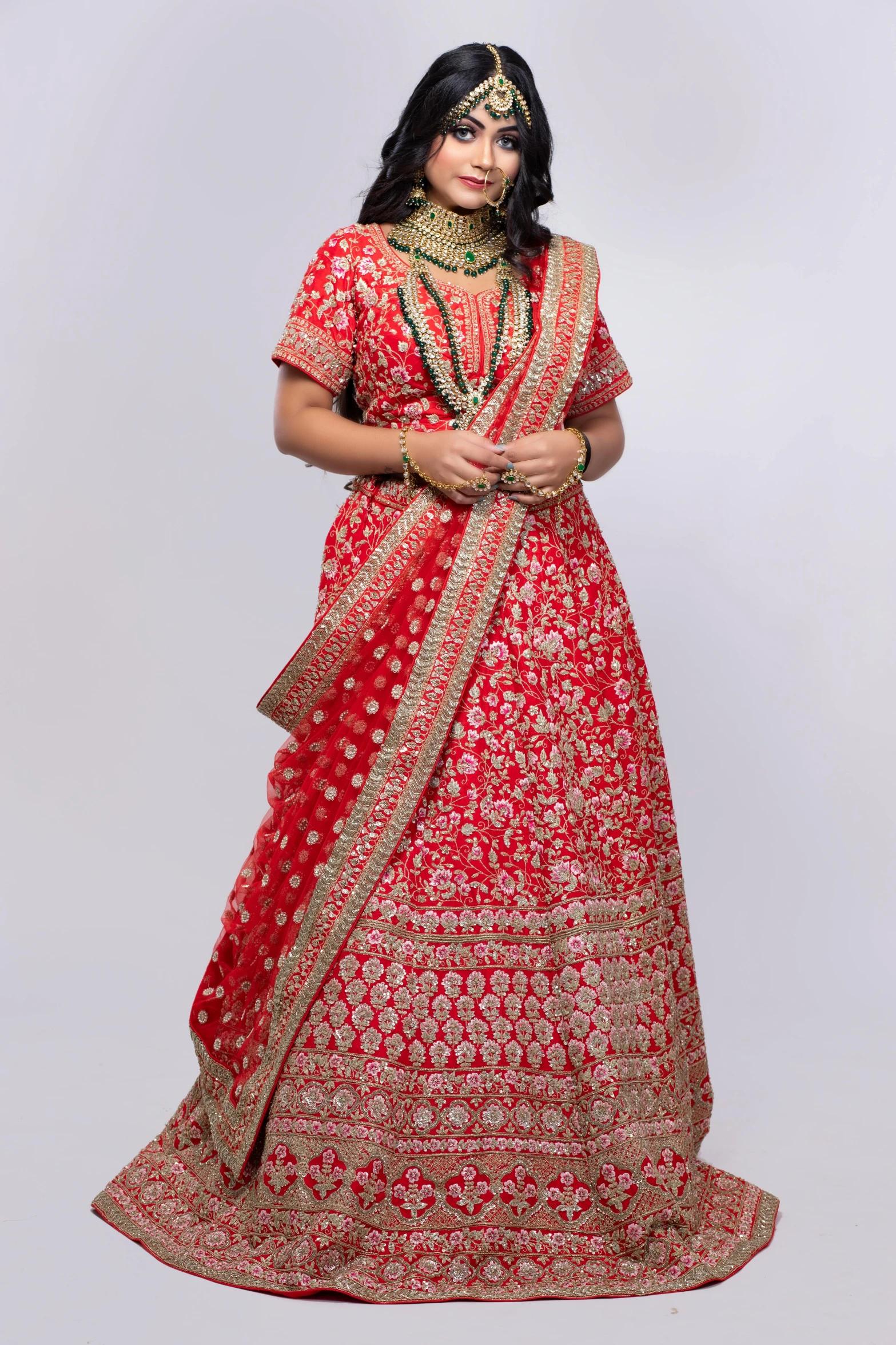 a woman in a red and gold lehenga, inspired by Tang Di, set against a white background, modest, official store photo, square