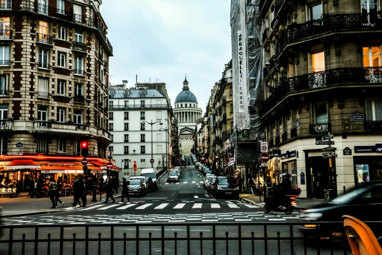 a city street filled with lots of traffic next to tall buildings, a photo, pexels contest winner, paris school, pantheon, a quaint, saint