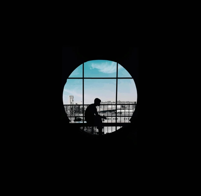 a silhouette of a person sitting in front of a window, a picture, pexels contest winner, conceptual art, circular windows, black. airports, window ( city ), musician