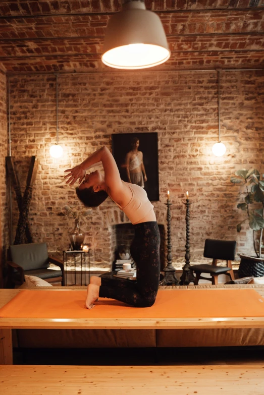 a man doing a handstand on top of a wooden table, by Micha Klein, unsplash, renaissance, sacral chakra, at home, arched back, profile image