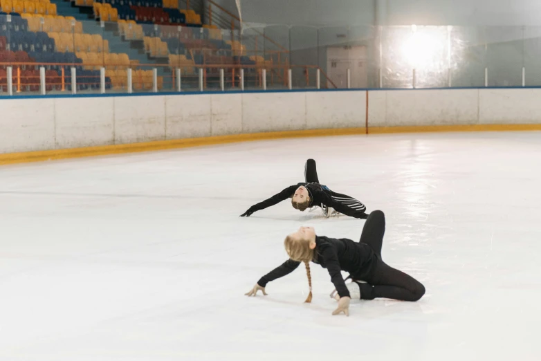 a couple of people that are on some ice, arabesque, doing splits and stretching, 15081959 21121991 01012000 4k, low quality photo, shot on sony a 7