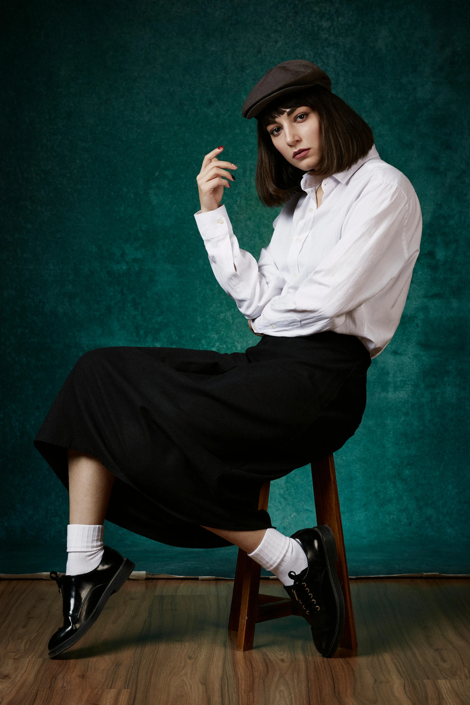 a woman sitting on top of a wooden chair, by Lucia Peka, trending on pexels, suprematism, dressed as schoolgirl, midi skirt, collared shirt, promotional image