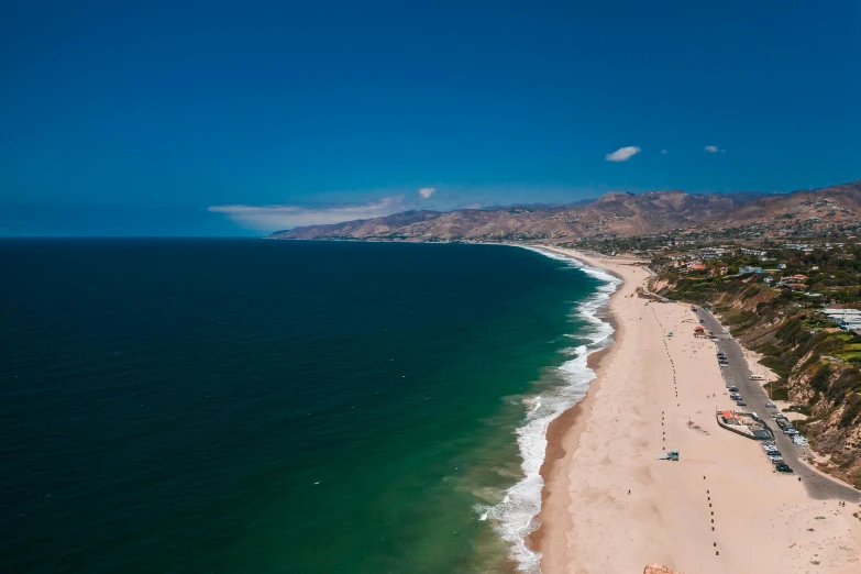 a large body of water next to a sandy beach, unsplash contest winner, renaissance, malibu canyon, 4k —height 1024 —width 1024, blue clear skies, the city of santa barbara