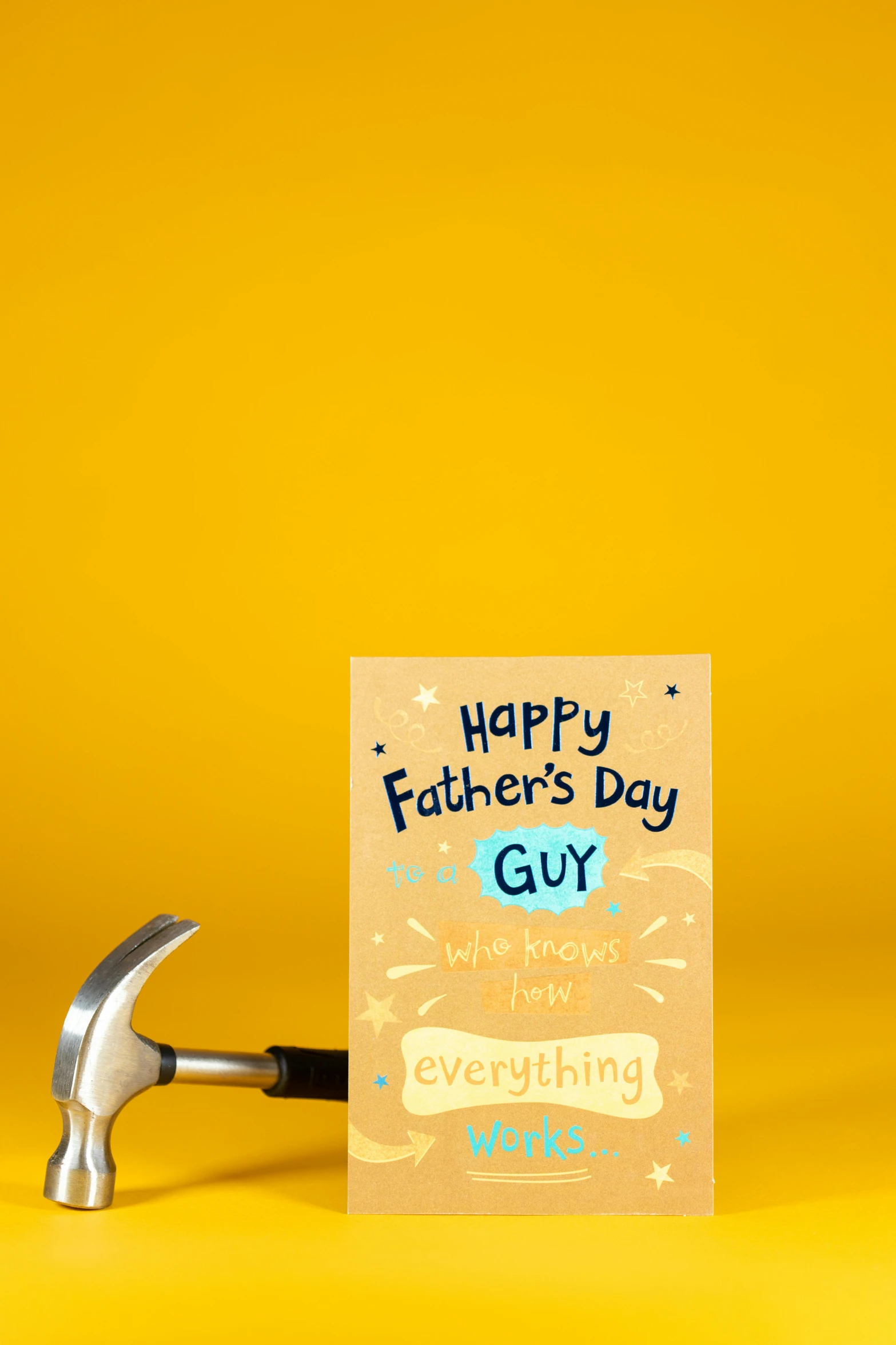 a hammer and a father's day card on a yellow background, front facing, my little everything, guy, thumbnail