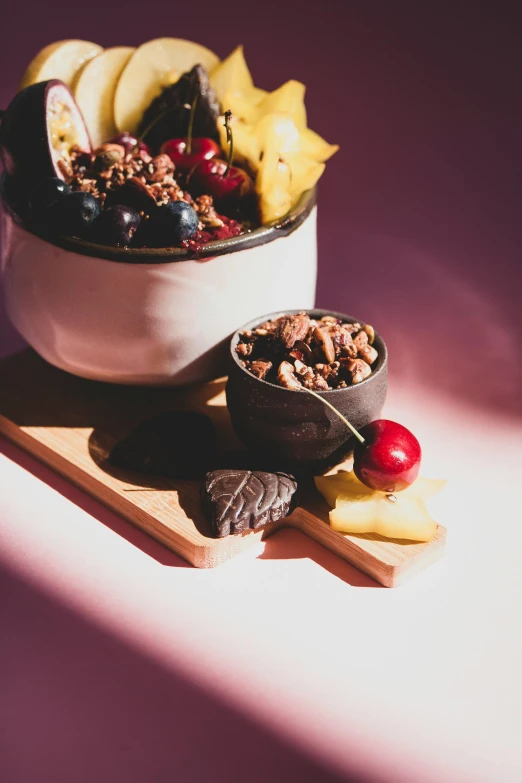 a bowl of fruit sitting on top of a cutting board, a still life, chocolate city, very crispy, botanicals, wax