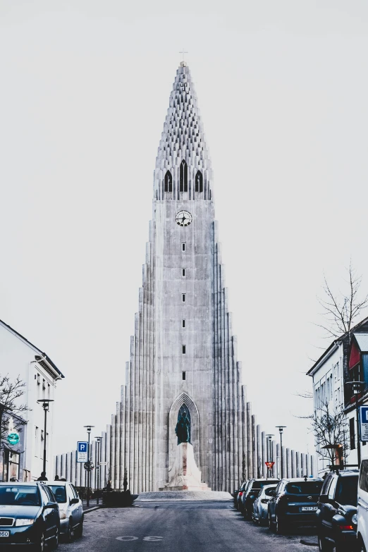 a very tall building sitting on the side of a road, inspired by Þórarinn B. Þorláksson, unsplash contest winner, modernism, cathedral!!!!!, front face, marilyn church h, icy