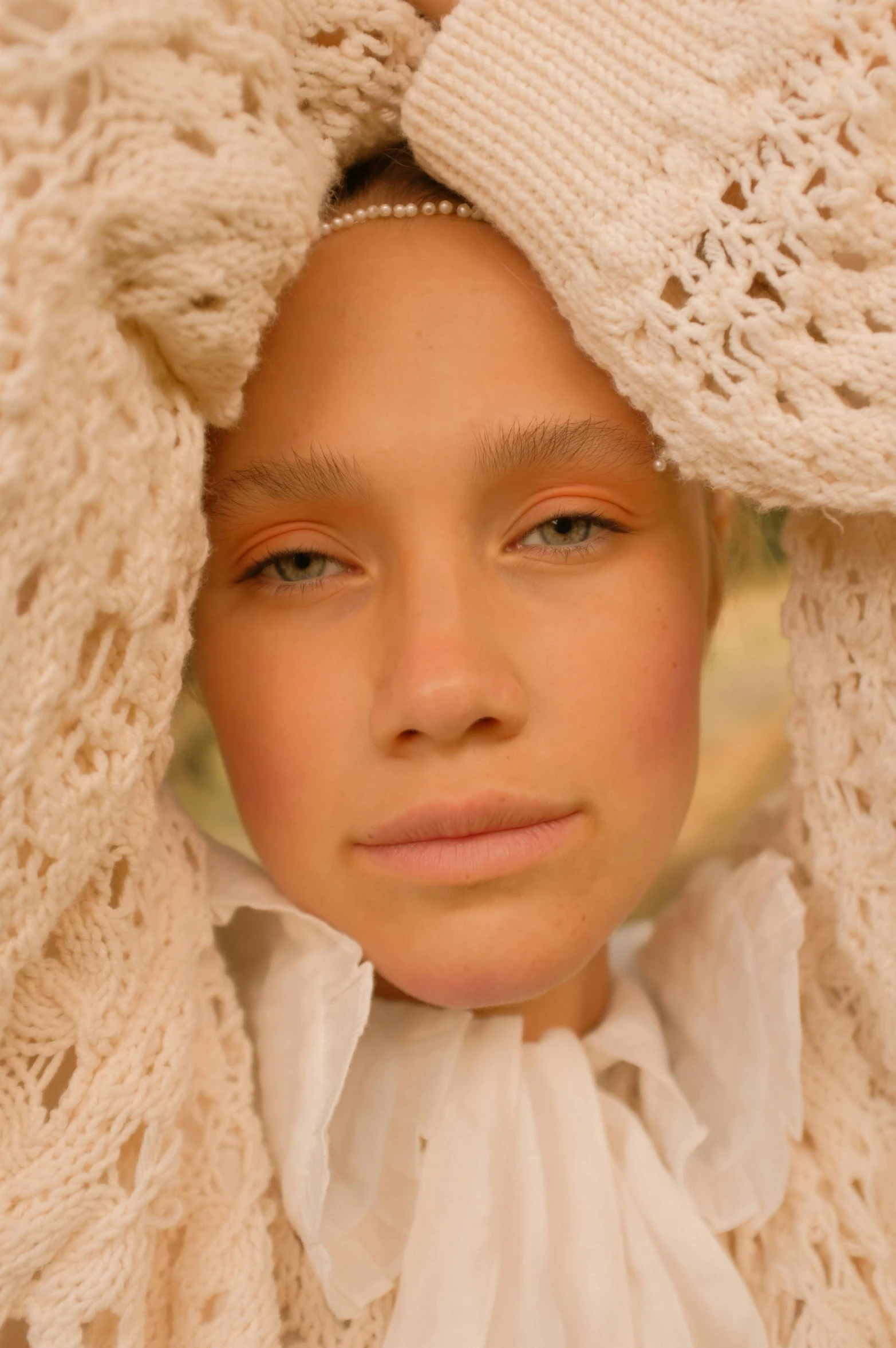 a close up of a person wearing a sweater, an album cover, inspired by Sophie Anderson, renaissance, photoshoot for skincare brand, white scarf, midsommar color theme, covered head