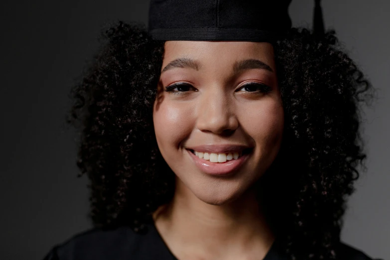 a woman wearing a graduation cap and gown, pexels contest winner, black teenage girl, portrait sophie mudd, with professional makeup, black