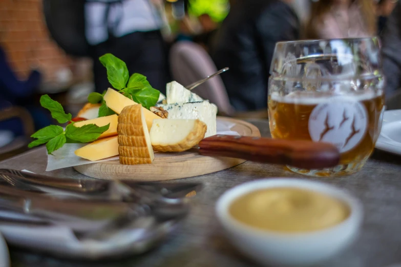 a close up of a plate of food on a table, by Lee Loughridge, pexels contest winner, renaissance, beers on the table, cheeses, straya, walking down