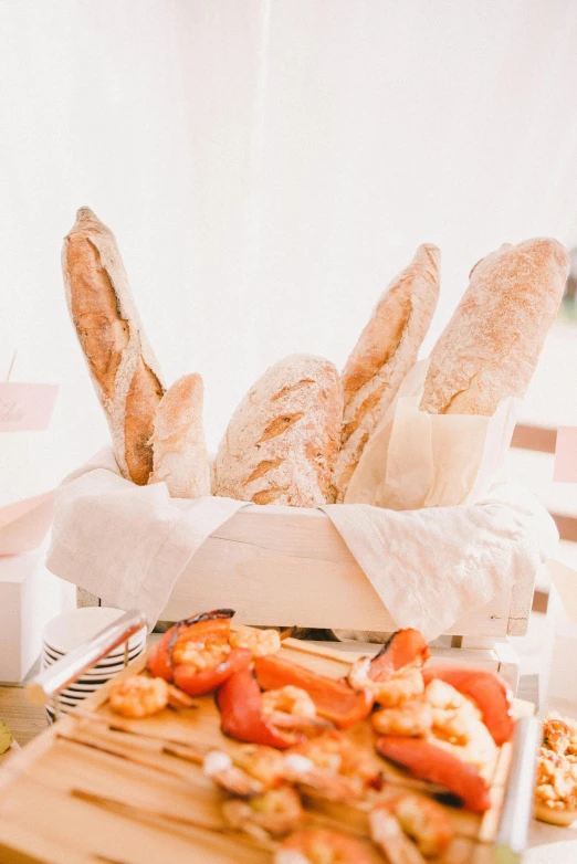 a table that has a bunch of food on it, unsplash, romanticism, baking french baguette, bright white light, event, striped