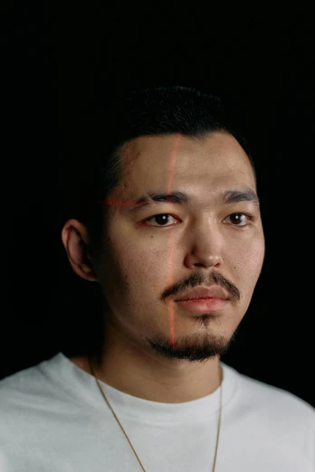 a man standing in front of a black background, a character portrait, inspired by Kanō Naizen, reddit, hyperrealism, hito steyerl, headshot profile picture, bo xun ling, 2 7 years old