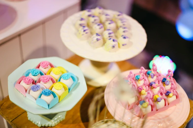 a couple of cakes sitting on top of a wooden table, a table full of candy