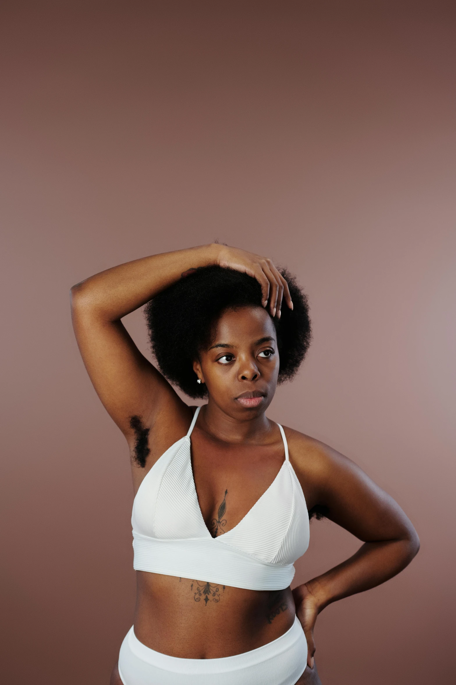 a woman in a white bikini posing for a picture, an album cover, by Dulah Marie Evans, trending on pexels, renaissance, hairy arms, black teenage girl, sport bra and shirt, armpit