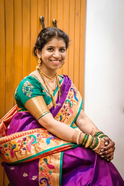 a woman in a purple and green sari, samikshavad, graduation photo, indoor picture, avatar image, wearing gold jewellery