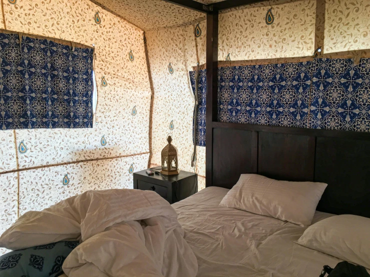 a bed sitting inside of a bedroom next to a window, inspired by Riad Beyrouti, unsplash, tent, sky blue, 2 5 6 x 2 5 6 pixels, mongolia