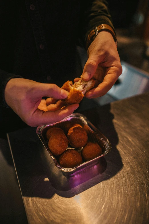 a close up of a person putting food in a container, les nabis, nugget, in the evening, serving suggestion, abcdefghijklmnopqrstuvwxyz