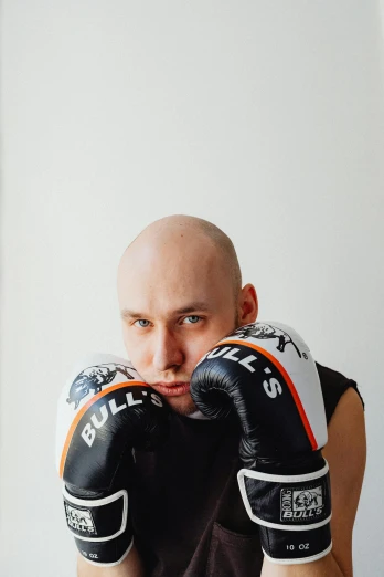 a bald man wearing a pair of boxing gloves, an album cover, inspired by Daryush Shokof, pexels contest winner, vitaly bugarov, bet face, instagram picture, profile image