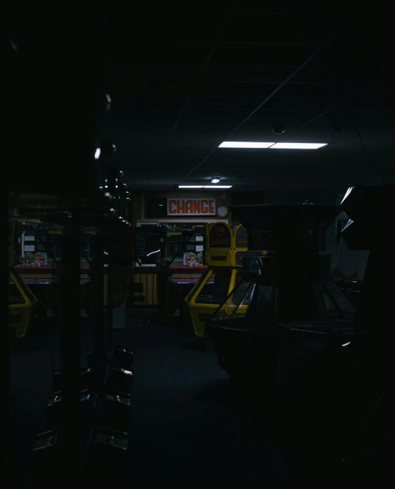 a row of arcade machines in a dark room, by Ryan Pancoast, low quality photo, cinematic footage, dingy gym, dark ( spaceship )