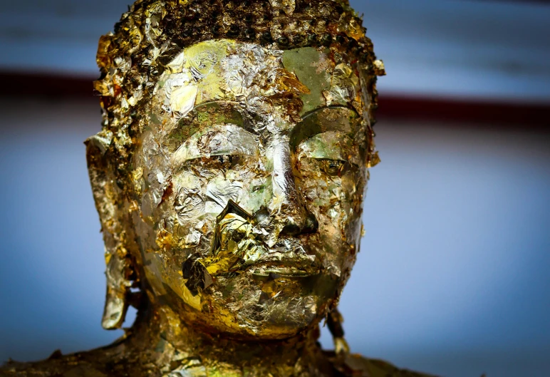 a close up of a statue of a person, pexels, gold flakes, thawan duchanee, portrait of an old, reflecting