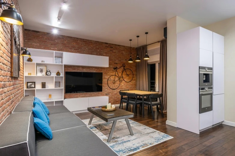 a living room filled with furniture and a brick wall, by Adam Marczyński, pexels contest winner, inside a modern apartment, open plan, simple ceiling, geometrically realistic