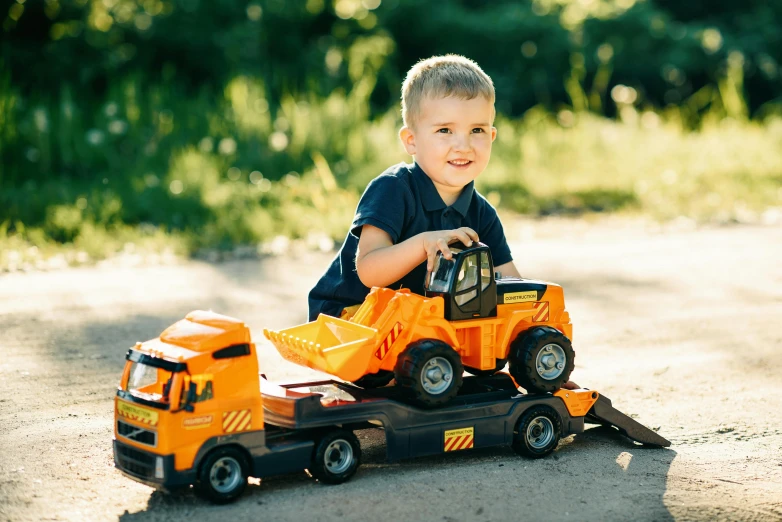 a young boy is playing with a toy truck, a portrait, pexels contest winner, figuration libre, portrait image, multi-part, jcb, high quality image