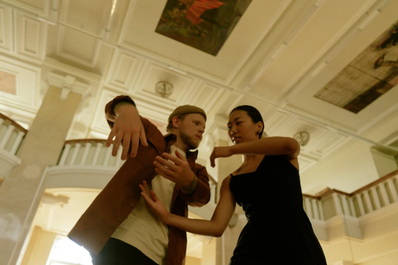 a couple of people that are standing in a room, choreographed, profile image, russian and japanese mix, a hand